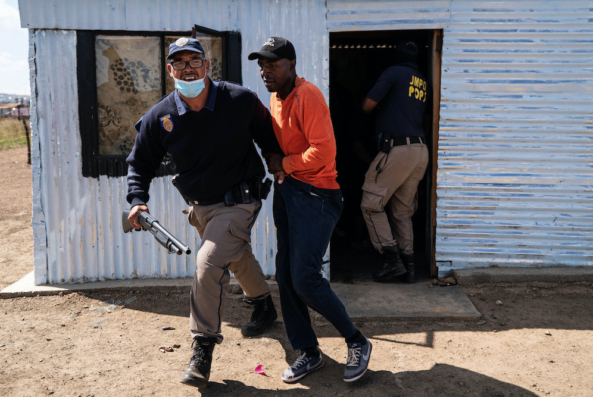 A metro policeman arrests a community member during an eviction in Lakeview Informal Settlement near Lawley, South of Johannesburg. Picture: James Oatway.